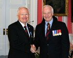 Retired Army Gen. Raymond Carpenter (left), the former acting director of the Army National Guard, shakes hands with His Excellency the Right Honorable David Johnston, governor general and commander-in-chief of Canada, after being presented the Canadian Meritorious Service Medal (Military Division) at Rideau Hall June 22 in Ottawa, Ont. The decoration is an important part of the Canadian Honors System, which recognizes excellence by either a single achievement or an activity over a specified period.