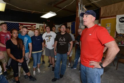 Marine Corps Sgt. Maj. Bryan B. Battaglia visits with service members who volunteered during a day of service in New Orleans, June 4, 2014.