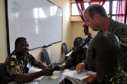 Air Force Lt. Col. Jeff Marks, of the Illinois Air National Guard's 183rd Fighter Wing, works with officers from Gambia and Togo during Operation Africa Endeavor in Doula, Cameroon. National Guard members from two states and the District of Columbia are participating in the annual communications exercise sponsored by U.S. Africa Command, which focuses on the interoperability of equipment and information sharing among military representatives throughout the African Union and partner nations.