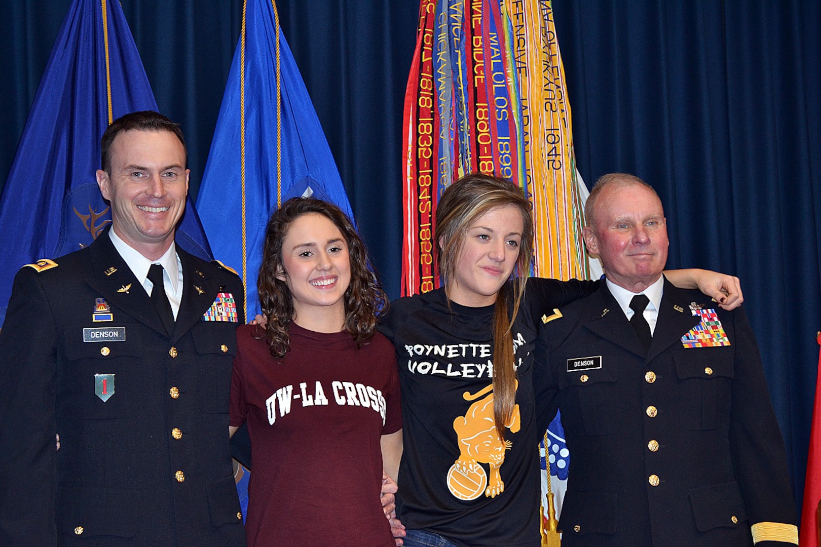 From left, Maj. Doug Denson, the executive officer of the 1st Battalion, 147th Aviation Regiment; his daughter, Rylie Denson; her friend, Autumn Peck and retired Brig. Gen. Kerry Denson pose for a photo following Rylie’s enlistment into the Wisconsin Army National Guard Feb. 25, 2014.