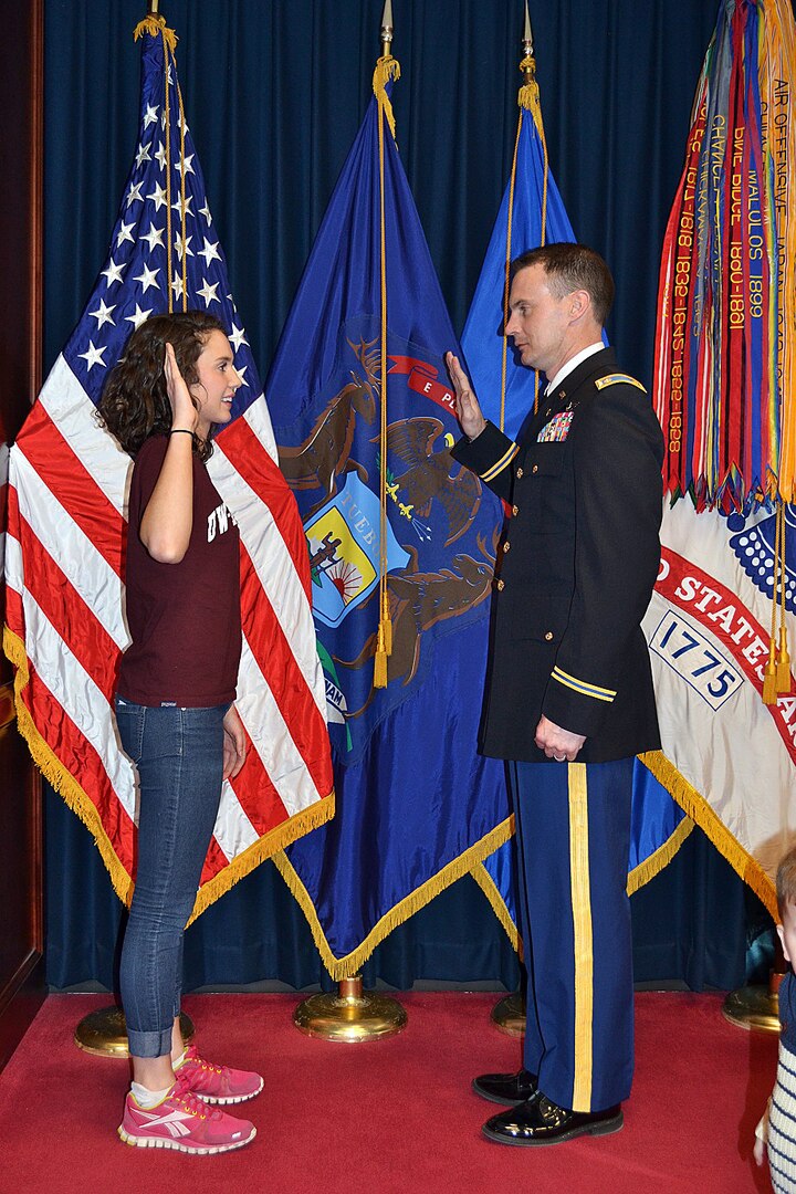 Rylie Denson receives the Oath of Enlistment from her father, Maj. Doug Denson, executive officer of the 1st Battalion, 147th Aviation Regiment, during a swearing-in ceremony Feb. 25, 2014, in Milwaukee. Rylie became the third generation of Densons to serve in the unit when she enlisted into the Wisconsin Army National Guard. Her grandfather, retired Brig. Gen. Kerry Denson, was the unit’s first commander. 