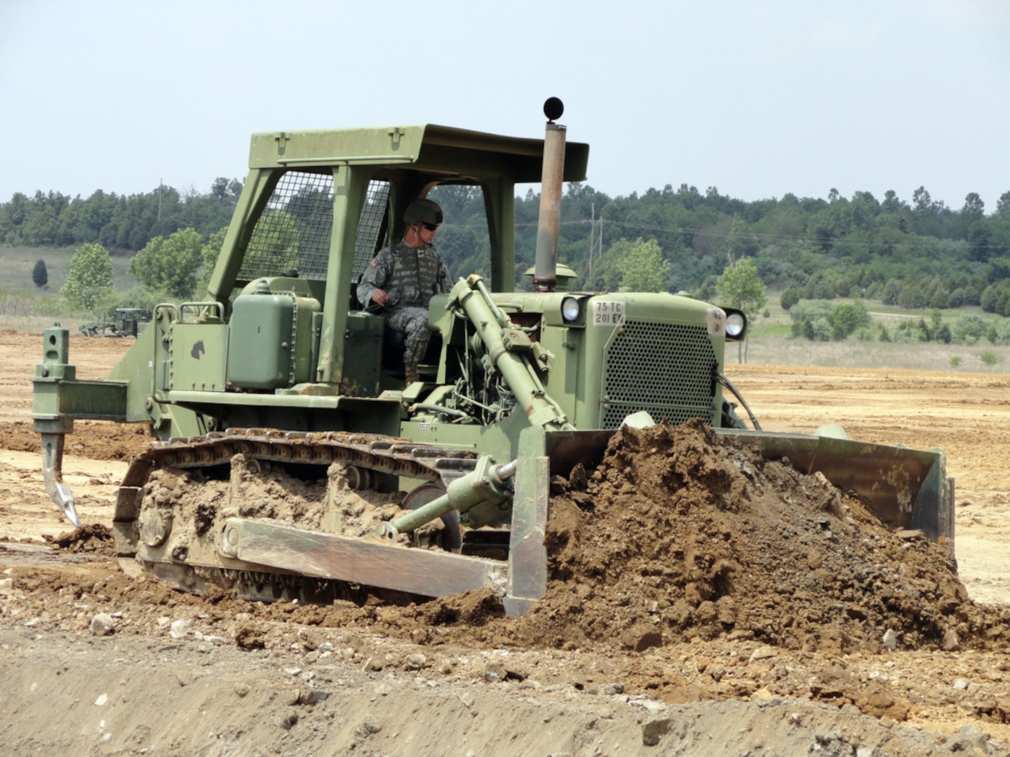 Spc. Donald Pace, of the 207th Horizontal Engineer Company, operates a D7 bulldozer to move dirt in efforts to build a new contingency operations location at Wendell H. Ford Regional Training Center in Greenville, Ky. Soldiers from the 201st and 206th Engineer Battalions worked on building living quarters, access roads and performed preliminary site surveys of a proposed air strip at the site.(U.S. Army Photo by Sgt. Sandra Fariss)