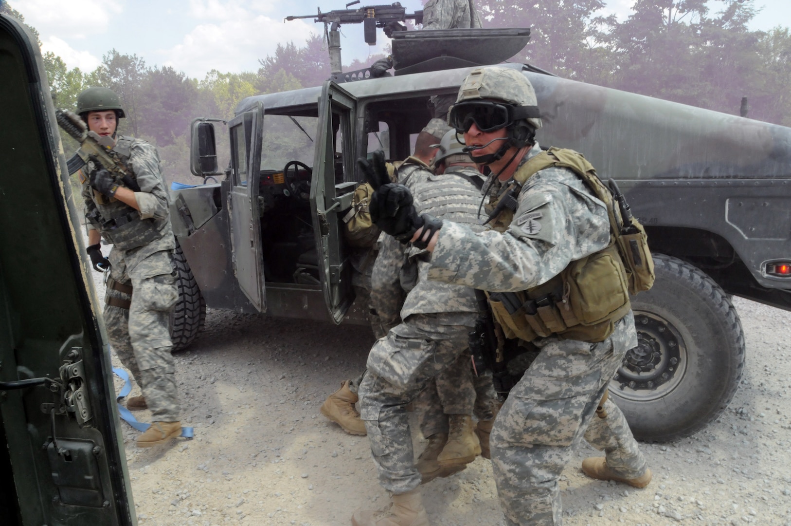 Soldiers from the West Virginia Army National Guard's 2nd Battalion, 19th Special Forces Group load a simulated casualty into a vehicle to be evacuated after a vehicle in their convoy was struck by a simulated improvised explosive device during training at Camp Atterbury Joint Maneuver Training Center.