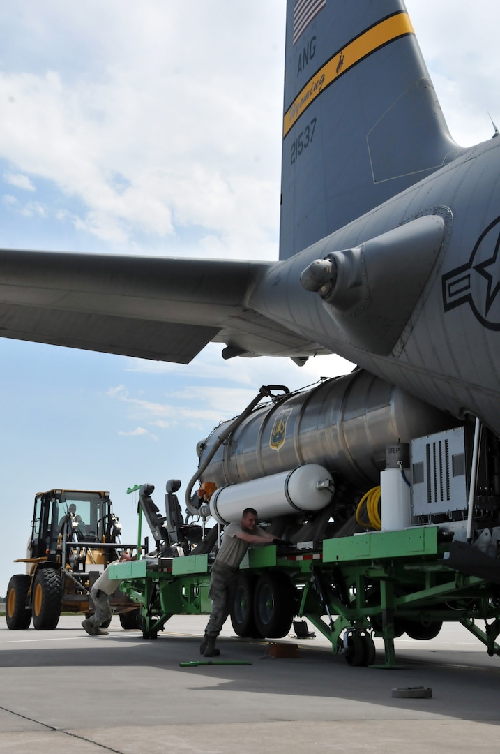 Members of the 153rd Airlift Wing load a U.S. Forest Service Modular Airborne Firefighting System II onto a C-130 Hercules aircraft in support of operations suppressing wildfires in Colorado. Working out of Peterson Air Force Base, Colo., the more than 65,000 gallons of retardant have been dropped by crews from the 153rd AW and 302nd Airlift Wing on the Waldo Canyon wildfire.