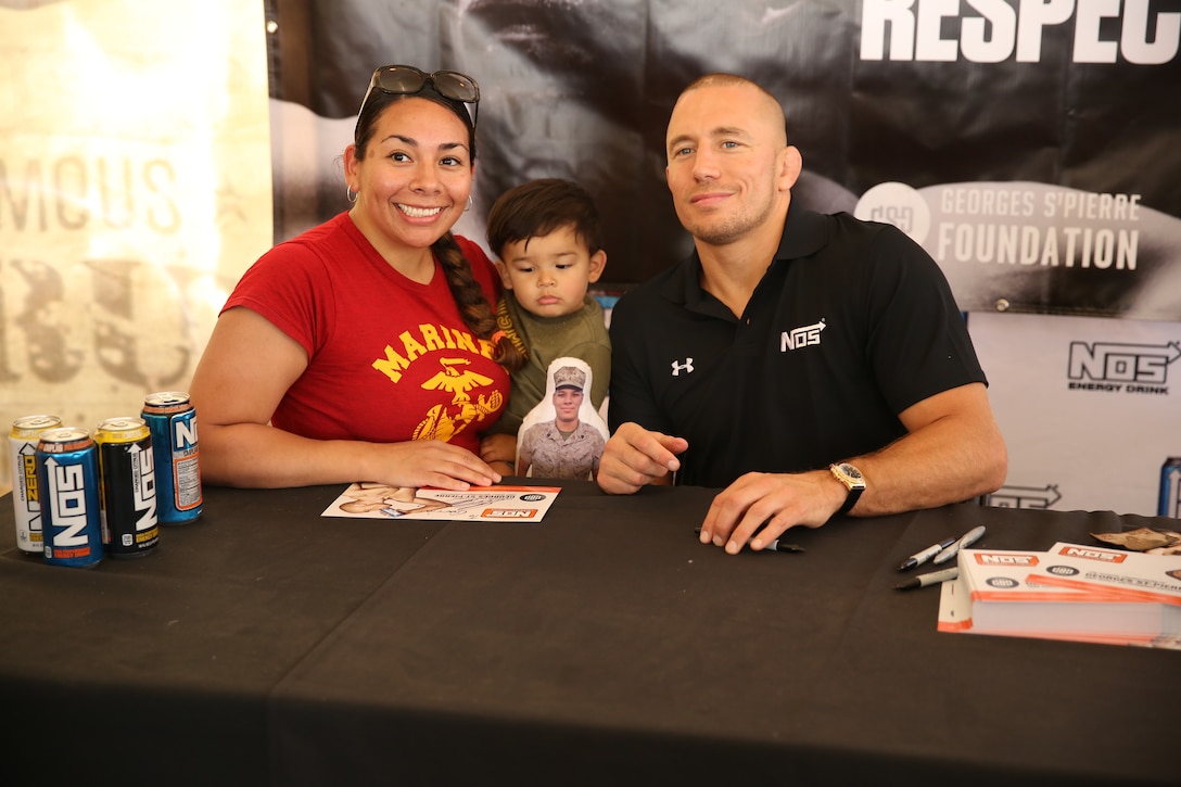 Georges St-Pierre, mixed martial artist and UFC world champion, meets Marine volunteers and runners at the 22nd World Famous Mud Run on Camp Pendleton June 8. St-Pierre took photos and signed autographs for Mud Run racers and service members during the visit.