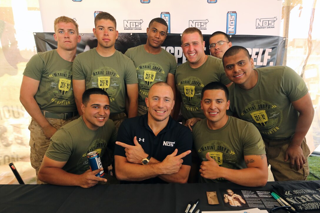 Georges St-Pierre, mixed martial artist and UFC world champion, meets Marine volunteers and runners at the 22nd World Famous Mud Run on Camp Pendleton June 8. St-Pierre took photos and signed autographs for Mud Run racers and service members during the visit.