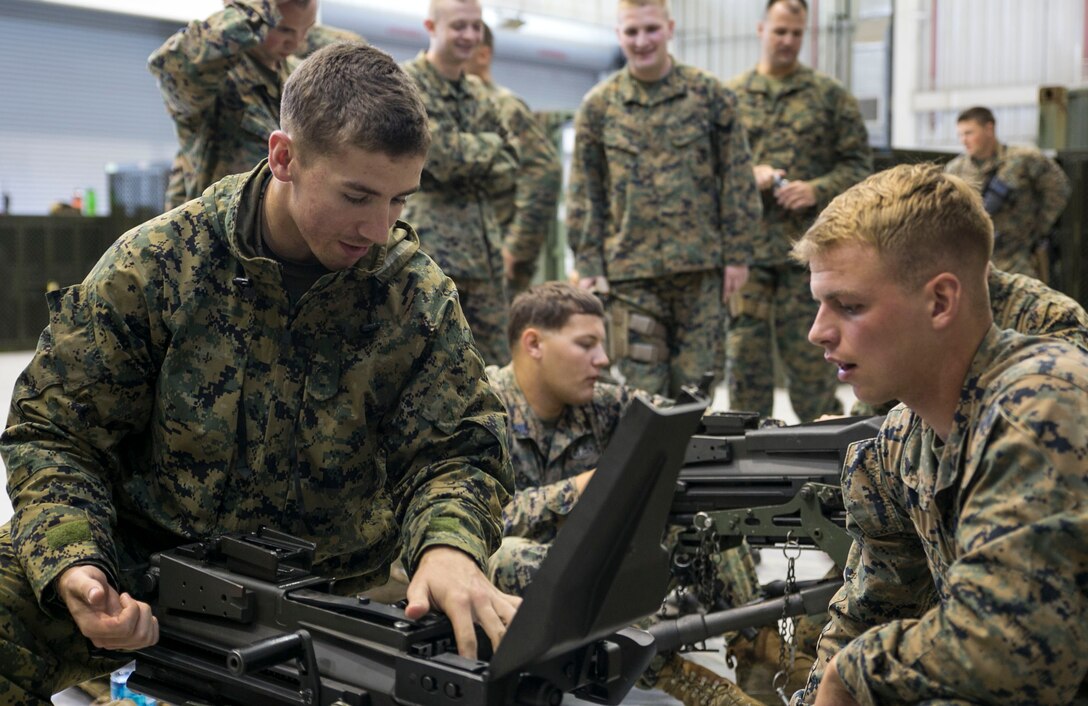 Cpl. Dennis E. Zeller, right, instructs Lance Cpl. Keith M. Raymond on the fundamentals of the MK19 40 mm automatic grenade launcher June 5 on Camp Mujuk, South Korea. The U.S. Marines familiarized themselves with the crew served weapon to enhance safety on ranges where they will train Republic of Korea Marines on the weapons employment as part of Korean Marine Exchange Program 14-8. KMEP 14-8 is one iteration in a series of continuous combined training exercises designed to enhance the ROK-U.S. alliance, promote stability on the Korean Peninsula, and strengthen ROK-U.S. military capabilities and interoperability. Zeller and Raymond are military policemen with 3rd Law Enforcement Battalion, III Marine Expeditionary Force Headquarters Group, III MEF. (U.S. Marine Corps photo by Lance Cpl. Drew Tech/Released)