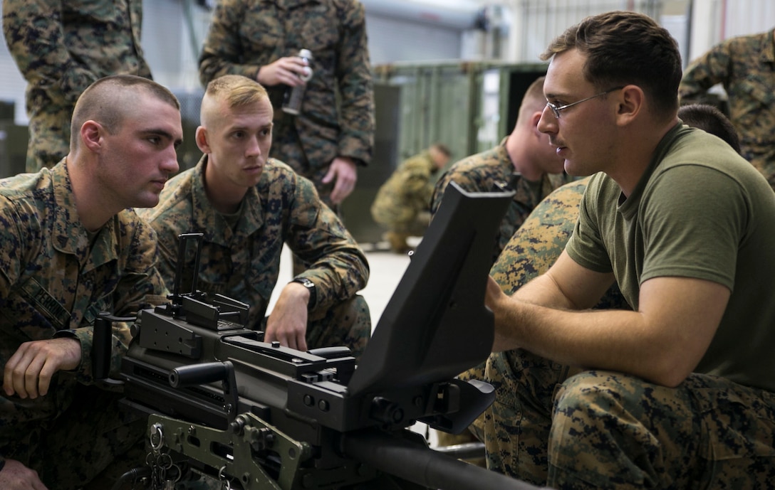 Lance Cpl. Jose A. Vivaldi, right, explains the cycle of operations for the MK19 40 mm automatic grenade launcher to Lance Cpl. Ryan Haylett, center, and Cpl. Brandon C. Perrine June 5 on Camp Mujuk, South Korea. The U.S. Marines familiarized themselves with the crew served weapon to enhance safety on ranges where they will train Republic of Korea Marines on the weapons employment as part of Korean Marine Exchange Program 14-8. KMEP 14-8 is one iteration in a series of continuous combined training exercises designed to enhance the ROK-U.S. alliance, promote stability on the Korean Peninsula, and strengthen ROK-U.S. military capabilities and interoperability. Vivaldi is a military policeman and range safety officer with 3rd Law Enforcement Battalion, III Marine Expeditionary Force Headquarters Group, III MEF. Haylett and Perrine are military policeman with 4th LE Bn., Force Headquarters Group, Marine Forces Reserve. (U.S. Marine Corps photo by Lance Cpl. Drew Tech/Released)