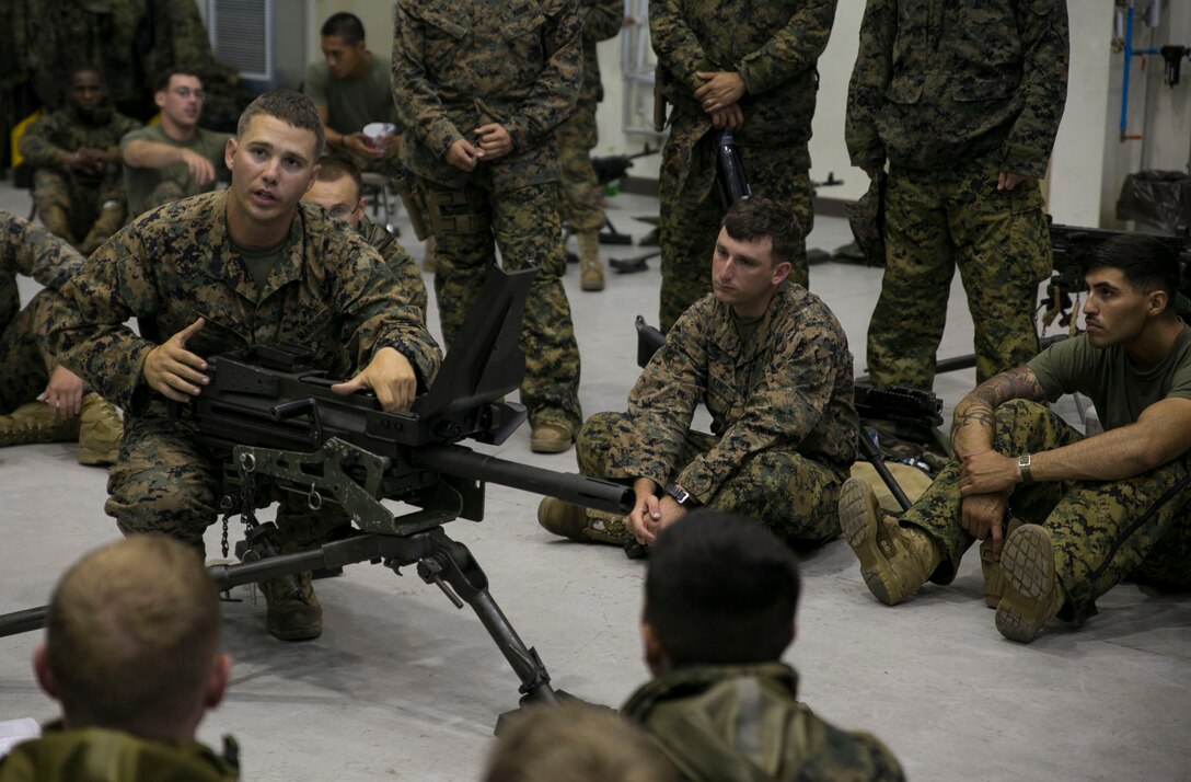 Staff Sgt. Eric J. Ellenberger, left, teaches the fundamentals of the MK19 40 mm automatic grenade launcher June 5 on Camp Mujuk, South Korea. The U.S. Marines familiarized themselves with the crew served weapon to enhance safety on ranges where they will train Republic of Korea Marines on the weapons employment as part of Korean Marine Exchange Program 14-8. KMEP 14-8 is one iteration in a series of continuous combined training exercises designed to enhance the ROK-U.S. alliance, promote stability on the Korean Peninsula, and strengthen ROK-U.S. military capabilities and interoperability. Ellenberger is a military policeman with 3rd Law Enforcement Battalion, III Marine Expeditionary Force Headquarters Group, III MEF. (U.S. Marine Corps photo by Lance Cpl. Drew Tech/Released)