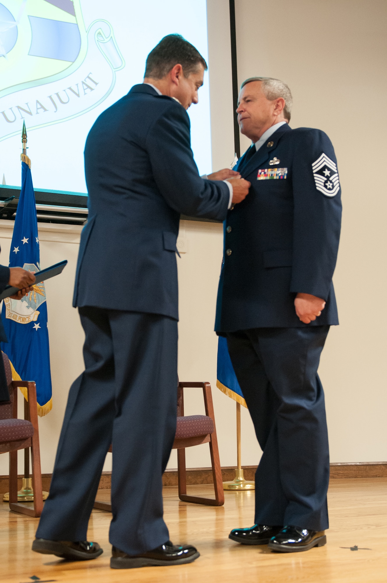 Col. Warren Hurst (left), Kentucky’s assistant adjutant general for Air, pins the Meritorious Service Medal on Chief Master Sgt. Curtis R. Carpenter, outgoing 123rd Airlift Wing command chief, during Carpenter’s retirement ceremony at the Kentucky Air National Guard Base in Louisville, Ky., on May 17, 2014. Carpenter served in the active-duty Air Force and Air National Guard for more than 34 years. (U.S. Air National Guard photo by Airman 1st Class Joshua Horton)