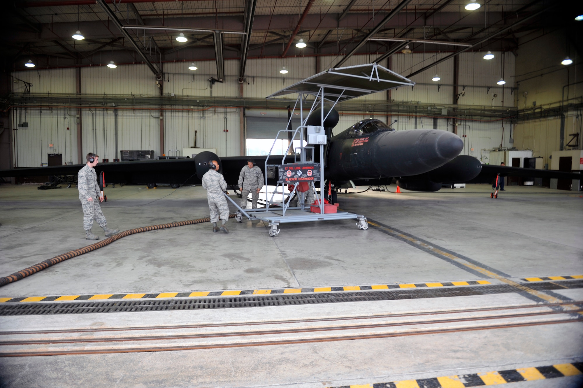 Members of the 5th Reconnaissance Squadron pull the ingress stand away from a U-2 Dragon Lady on Osan Air Base, Republic of Korea, June 5, 2014. The mission of the 5th RS is to operate its fleet of U-2s to conduct reconnaissance and surveillance missions. (U.S. Air Force photo/Senior Airman David Owsianka)