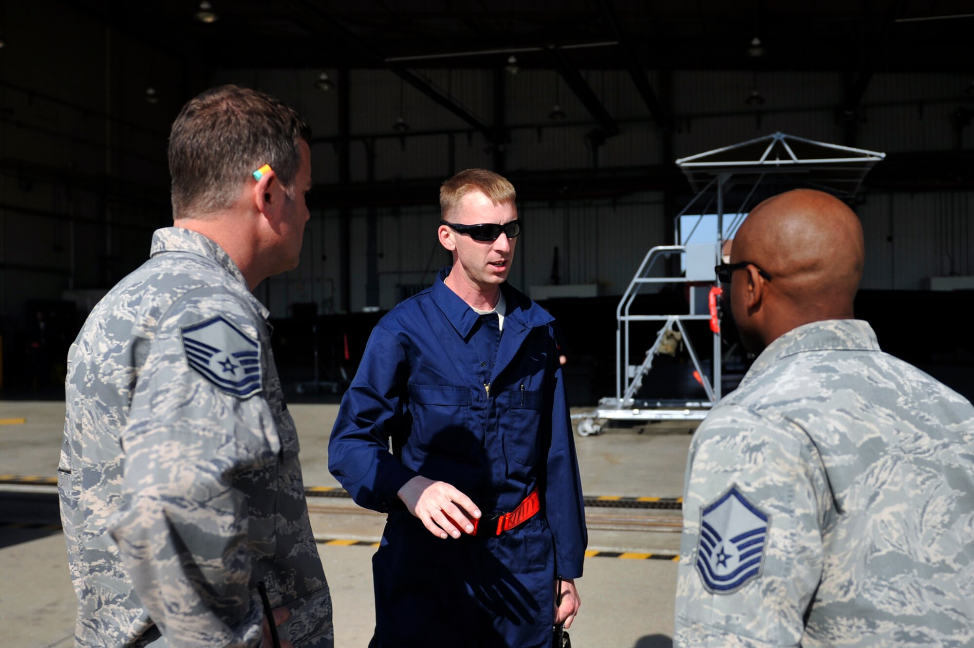 Tech. Sgt. Christopher Trusnik, 5th Reconnaissance Squadron expediter, briefs production supervisors on the location of a leak after inspecting a U-2 Dragon Lady on Osan Air Base, Republic of Korea, May 15, 2014. Once the aircraft was fixed, crew chiefs refueled the aircraft and service it with oxygen. (U.S. Air Force photo/Senior Airman David Owsianka) 