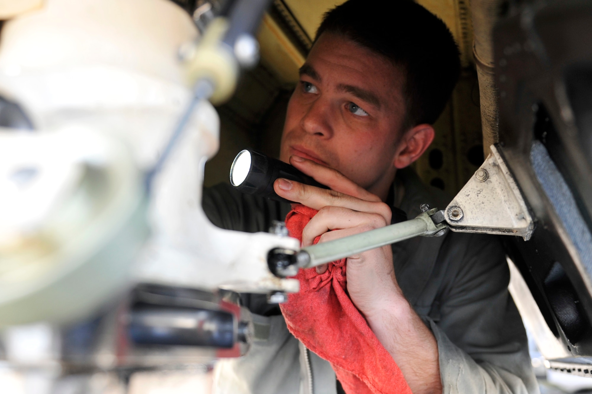 Senior Airman Peter McMurray, 5th Reconnaissance Squadron crew chief, inspects a U-2 Dragon Lady’s rear aircraft tail landing gear bay for the next day’s flight on Osan Air Base, Republic of Korea, May 15, 2014. The aircraft uses a bicycle configuration with a forward set of main wheels located just behind the cockpit, and a rear set of main wheels behind the engine. (U.S. Air Force photo/Senior Airman David Owsianka)
