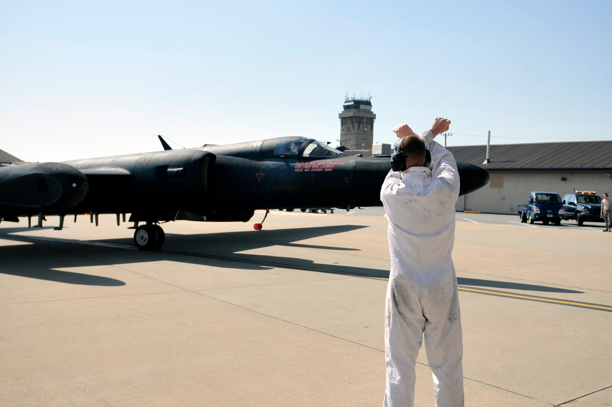 Tech. Sgt. Christopher Trusnik, 5th Reconnaissance Squadron expediter, signals a U-2 Dragon Lady to stop on Osan Air Base, Republic of Korea, May 15, 2014. The 5th RS crew chiefs are split into two shifts – preparation and launch, and recovery and inspection. (U.S. Air Force photo/Senior Airman David Owsianka)