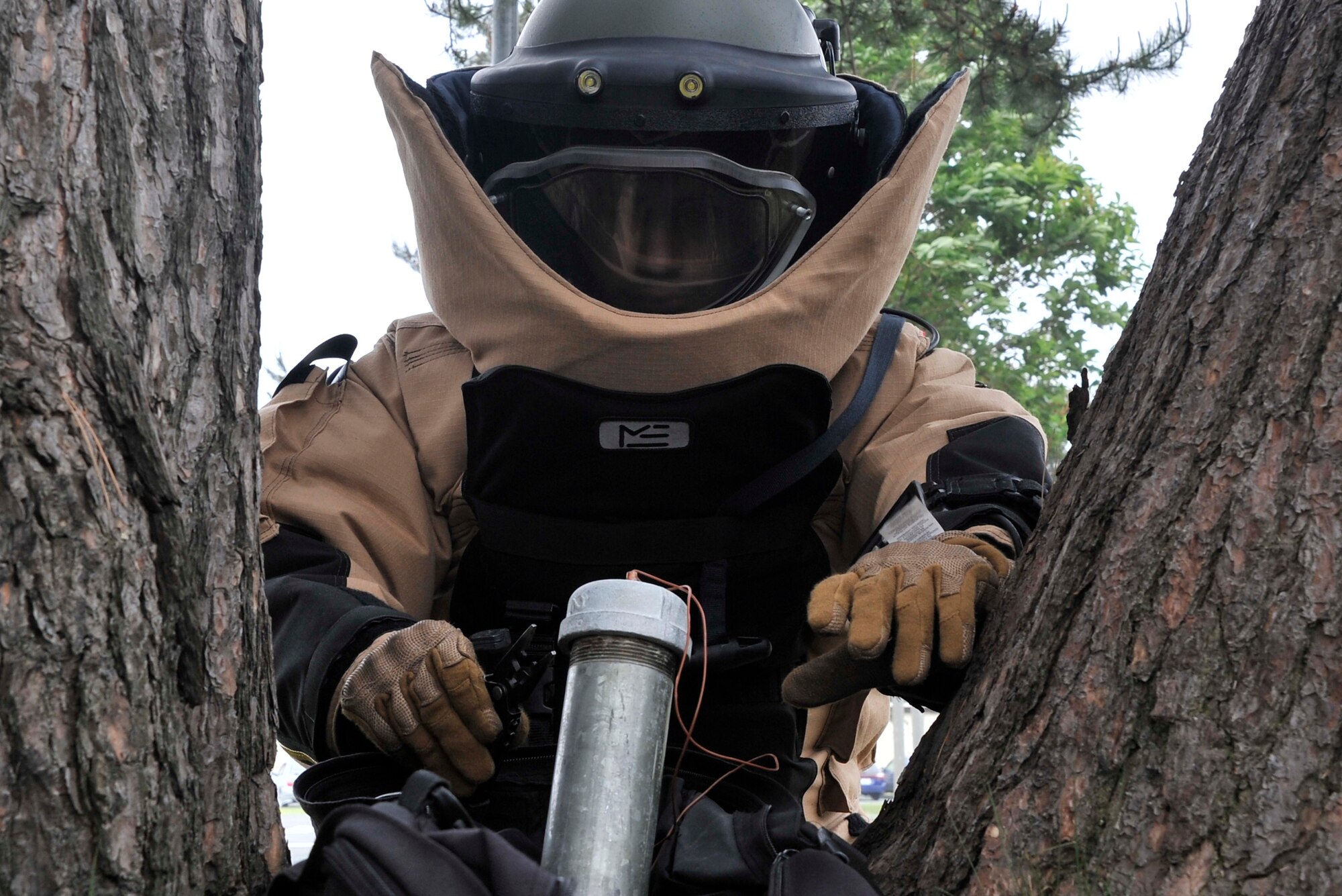 U.S. Air Force Airman 1st Class Marc Cooperman, 35th Civil Engineer Squadron explosive ordnance disposal technician, demonstrates the proper technique for disarming a homemade explosive device during a training exercise at Misawa Air Base, Japan, June 6, 2014. Cooperman is trained to handle improvised explosive devices like this pipe bomb and employs tools ranging from high-tech remotely controlled vehicles to simple pliers to safely disarm explosives. (U.S. Air Force photo/Airman 1st Class Patrick Ciccarone)