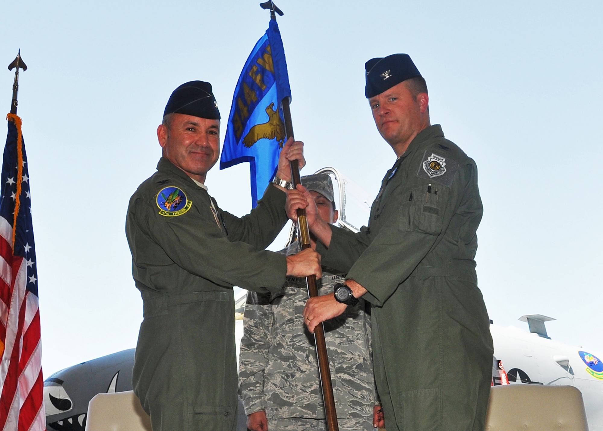 Col. Kurt J. Gallegos, 944th Fighter Wing commander, poses with the incoming 924th Fighter Group Commander Col. Thomas McNurlin as he hands him the guidon during a Change of Command ceremony June 8. (U.S. Air Force photo/Maj. Elizabeth Magnusson)
