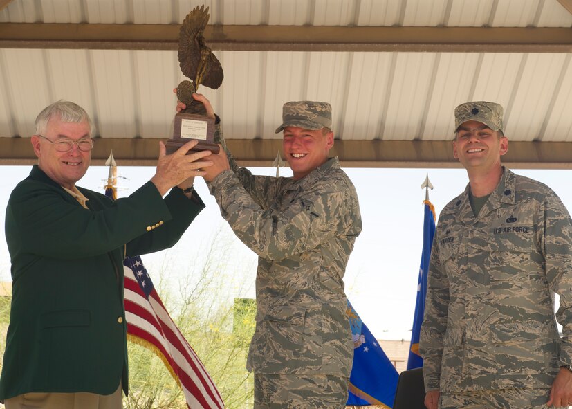 Retired Lt.Gen. Nicholas Kehoe presents the Daedalion Award to Airman Dylan Pentek, 49th Logistics Readiness Squadron vehicle operator, and Lt. Col. Robert Bearden, 49th LRS commander, during the Daedalion Award presentation at Holloman Air Force Base, N.M., June 6. Holloman’s LRS was once again awarded the title of best LRS in the U.S. Air Force for 2013. The Maj. Gen. Warren R. Carter Logistics Readiness Squadron Effectiveness Award is presented annually by the Order of Daedalions to the base that has achieved the best supply effectiveness record in the U.S. Air Force in support of mission aircraft and weapons. (U.S. Air Force photo by Airman 1st Class Leah Ferrante/Released)