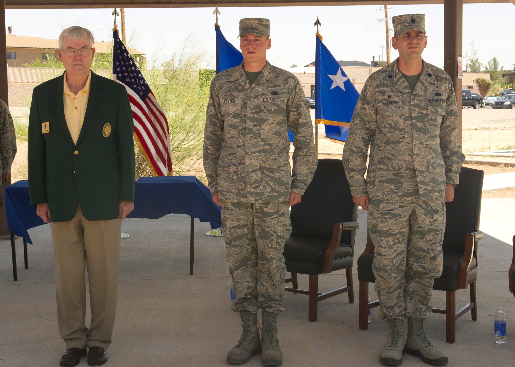 Retired Lt.Gen. Nicholas Kehoe, Airman Dylan Pentek, 49th Logistics Readiness Squadron vehicle operator, and Lt. Col. Robert Bearden, 49th LRS commander, stand for the reading of the order during the Daedalion Award presentation at Holloman Air Force Base, N.M., June 6. Holloman’s LRS was once again awarded the title of best LRS in the U.S. Air Force for 2013. The Maj. Gen. Warren R. Carter Logistics Readiness Squadron Effectiveness Award is presented annually by the Order of Daedalions to the base that has achieved the best supply effectiveness record in the U.S. Air Force in support of mission aircraft and weapons. (U.S. Air Force photo by Airman 1st Class Leah Ferrante/Released)