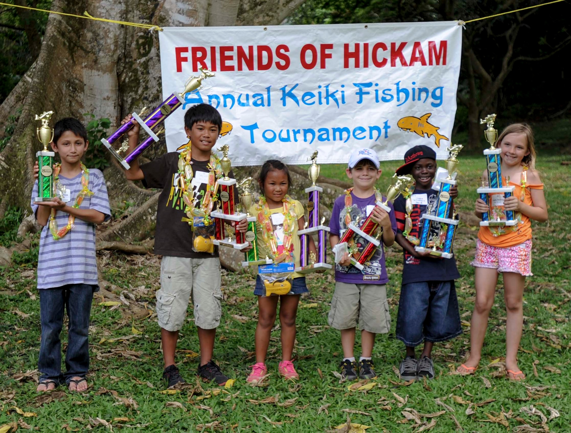 The first, second and third place winners from the 5-8 year-old category and 9-12 year-old category pose with their trophies following the 15th Annual Keiki Fishing Tournament t at the Ho’omaluhia Botanical Garden in Kaneohe, Hawaii, June 4, 2014. Though every child was declared a winner and took home a prize, trophies were awarded to the children who caught the most fish and the biggest fish. (U.S. Air Force photo/Tech. Sgt. Terri Paden)