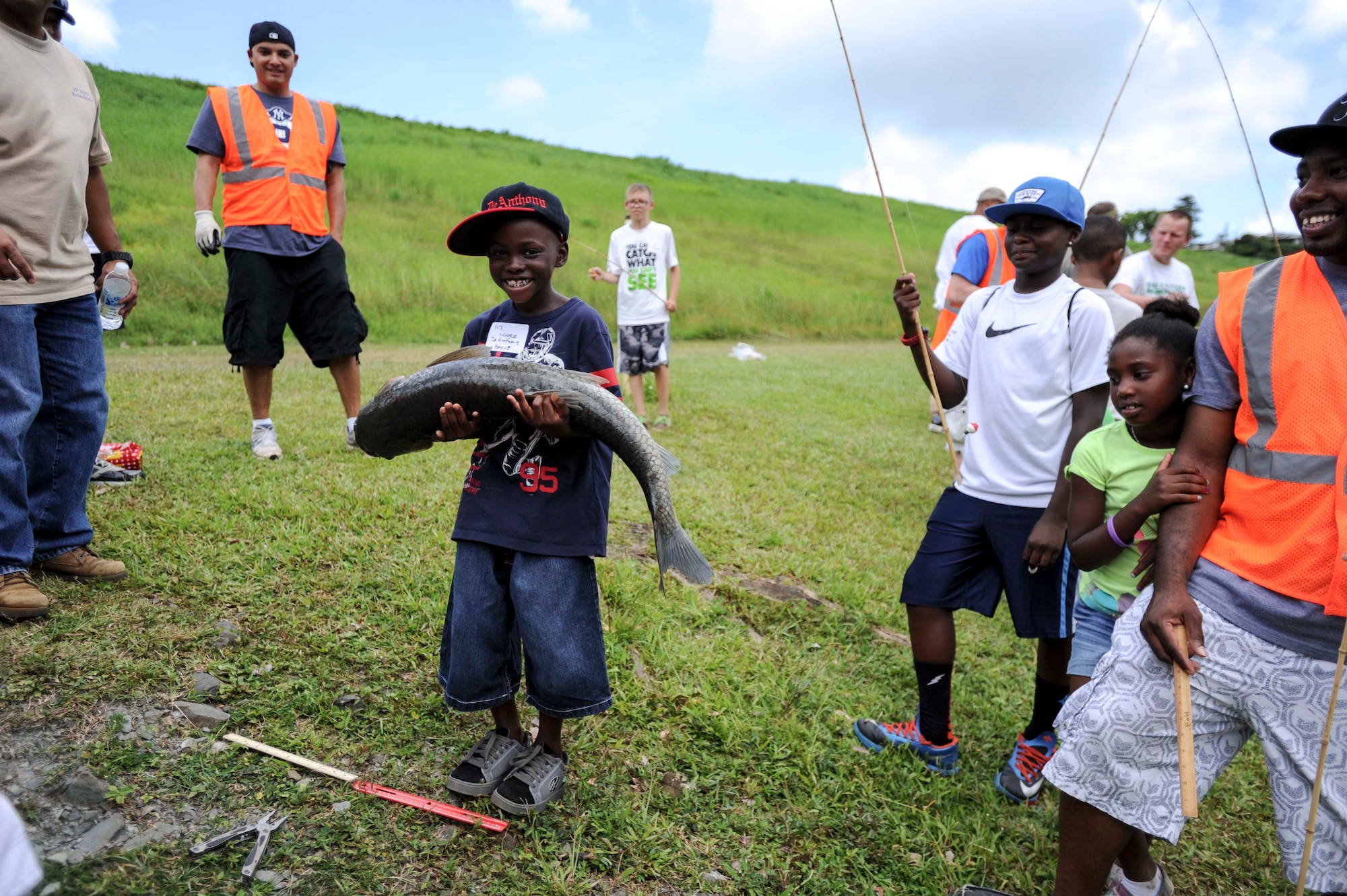 De Anthony Moore, 8, poses with his prize-winning catch, a 34 ½ pound catfish, during the 15th Annual Keiki Fishing Tournament at the Ho’omaluhia Botanical Garden in Kaneohe, Hawaii, June 4, 2014. Moore beat out more than 120 Hickam Keiki to take home the first place trophy for largest catch of the day during the free event sponsored by the Friends of Hickam. (U.S. Air Force photo/Tech. Sgt. Terri Paden)