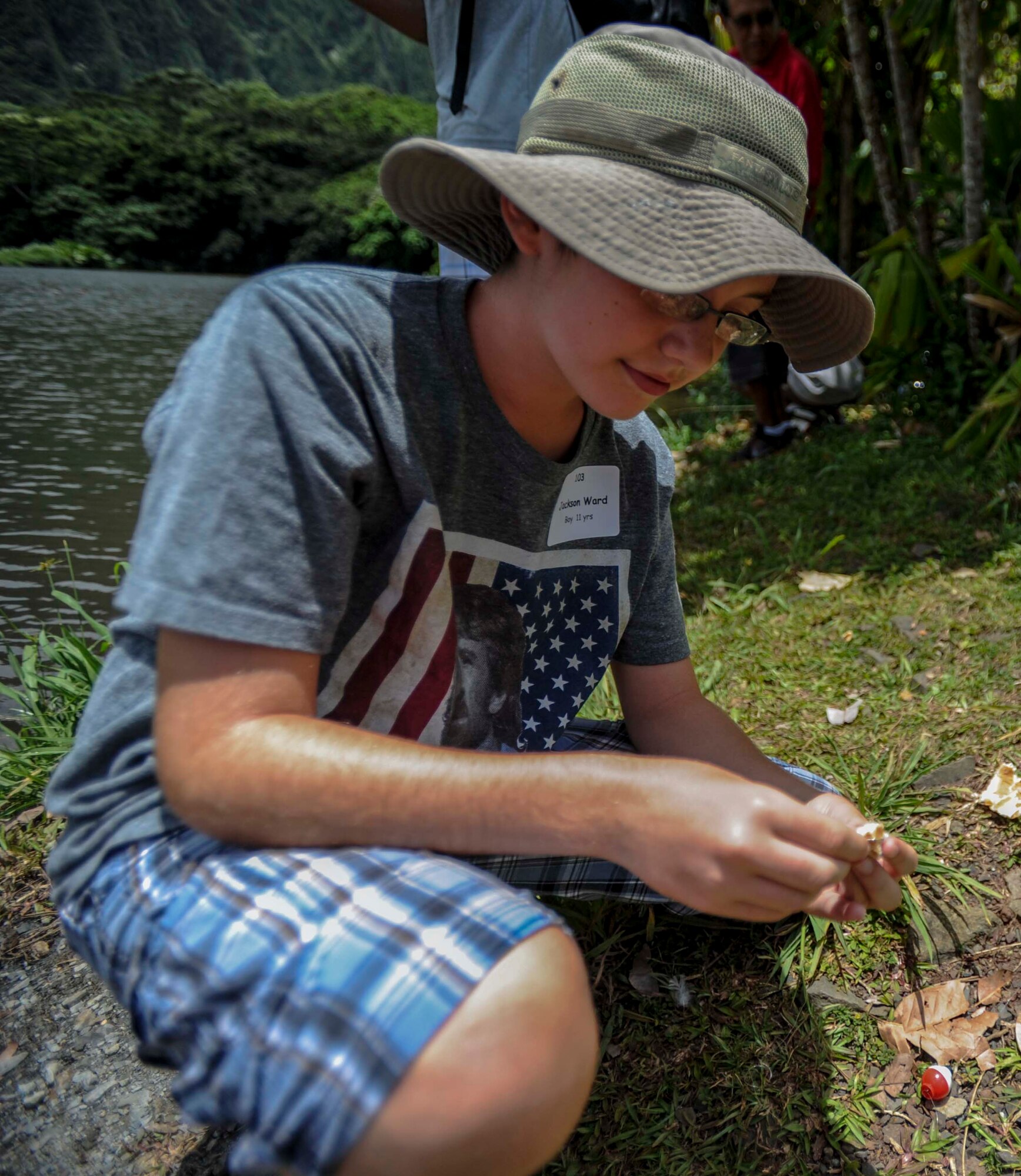Jackson Ward, 11, puts a piece of bread on his hook during the 15th Annual Keiki Fishing Tournament at the Ho’omaluhia Botanical Garden in Kaneohe, Hawaii, June 4, 2014. The bread was used as bait to catch Small Mouth Bass, Catfish, Red Devil Fish and Tilapia during the free event sponsored by the Friends of Hickam. (U.S. Air Force photo/Tech. Sgt. Terri Paden)