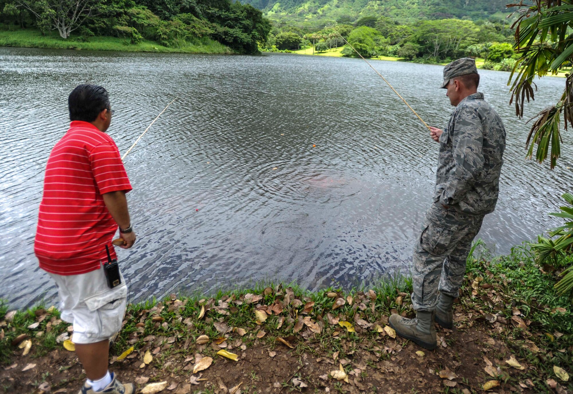 Wayne Iseri, Friends of Hickam president, and Col. Johnny Roscoe, 15th Wing commander, compete to see who will catch the first fish of the day to kick off the 15th Annual Keiki Fishing Tournament at the Ho’omaluhia Botanical Garden in Kaneohe, Hawaii, June 4, 2014. (It was a close call, but Iseri ultimately won the friendly competition). The Keiki Fishing Tournament is a free event hosted by the Friends of Hickam organization to support, promote and foster strong community relations with military families. (U.S. Air Force photo/Tech. Sgt. Terri Paden)