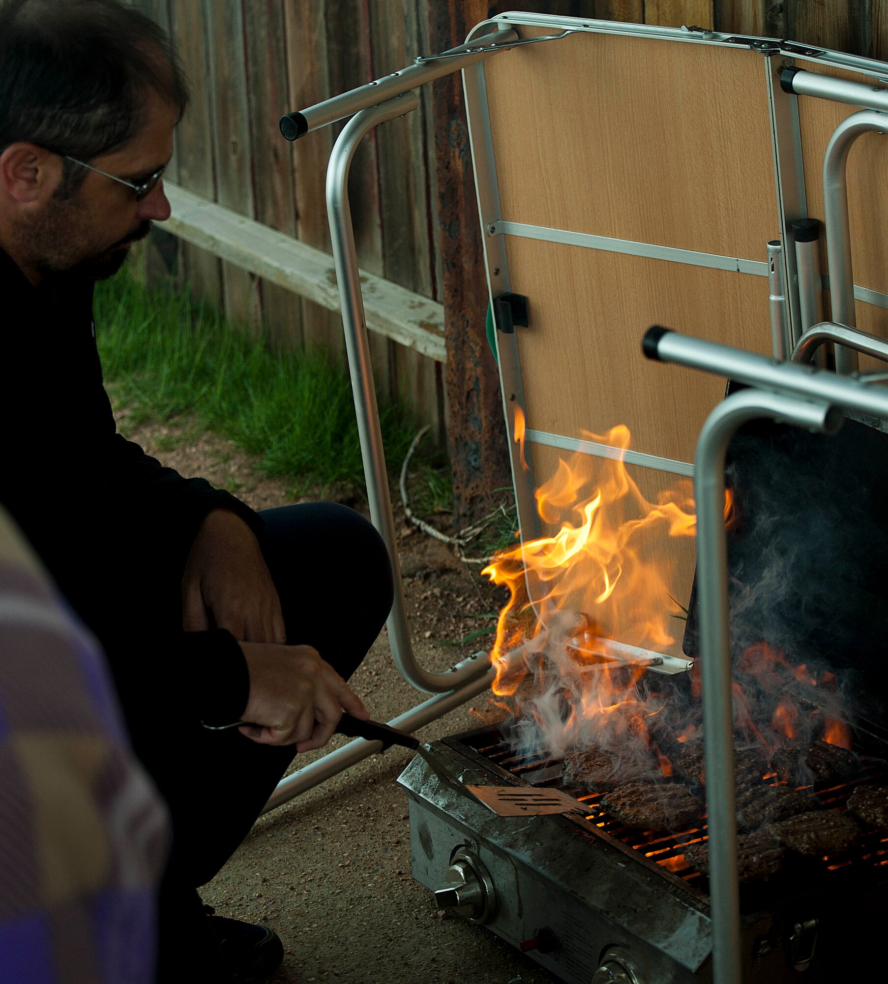 140608-F-GZ967-020 Gus Schliffke, Outdoor Recreation employee, cooks burgers for Airmen May 8 during a trip to Curt Gowdy State Park, Wyo. Outdoor Rec. provided food for the Airmen who joined in the trip. (U.S. Air Force photo by Airman 1st Class Brandon Valle) 