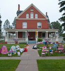 Items for sale sit outside the Farfour family's historic brick home on F.E. Warren Air Force Base, Wyo., during the base-wide yard sale June 7, 2014. Alison and Ava Farfour, daughters of Col. George Farfour, Task Force 214 director, set up the display. (U.S. Air Force photo by Airman 1st Class Jason Wiese)