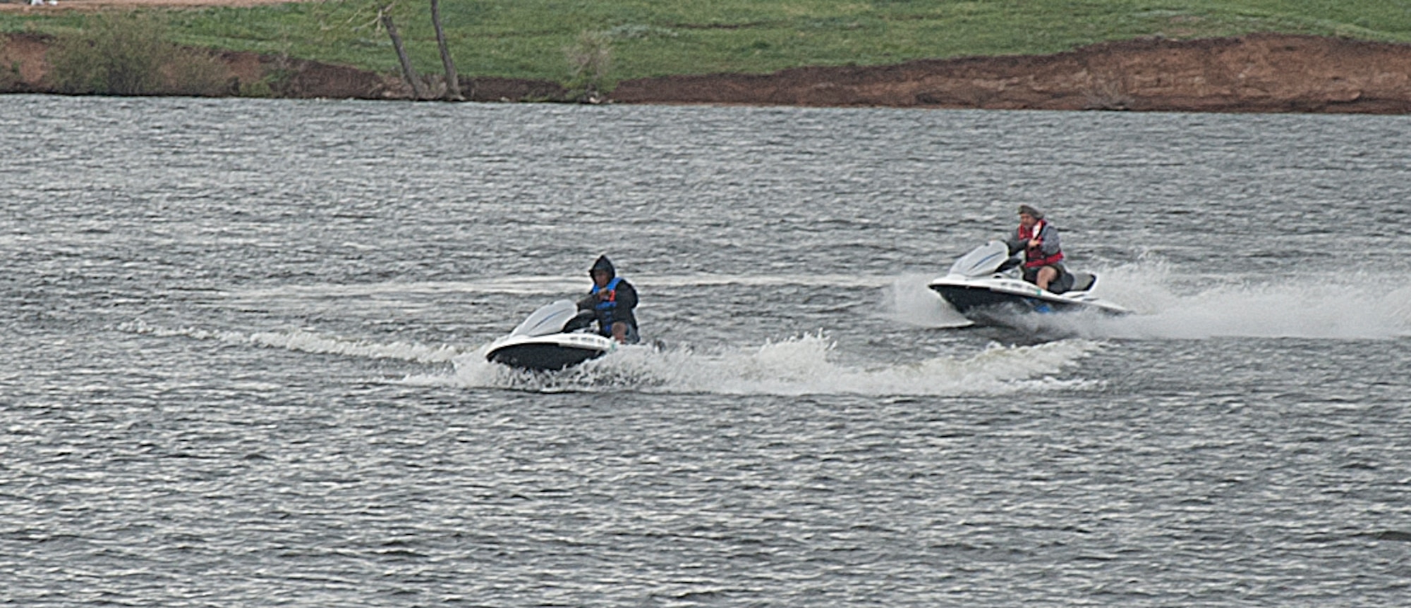 140608-F-GZ967-004 Roy Hinson, Outdoor Recreation employee, and Airman 1st Class Jennifer Ligali, 90th Force Support Squadron, ride a pair of jet skis May 8 on Granite Springs Reservoir, Curt Gowdy State Park, Wyo.  Outdoor Rec. provided the jet skis for Airmen to ride while out at the lake.  (U.S. Air Force photo by Airman 1st Class Brandon Valle)