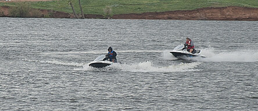 140608-F-GZ967-004 Roy Hinson, Outdoor Recreation employee, and Airman 1st Class Jennifer Ligali, 90th Force Support Squadron, ride a pair of jet skis May 8 on Granite Springs Reservoir, Curt Gowdy State Park, Wyo.  Outdoor Rec. provided the jet skis for Airmen to ride while out at the lake.  (U.S. Air Force photo by Airman 1st Class Brandon Valle)