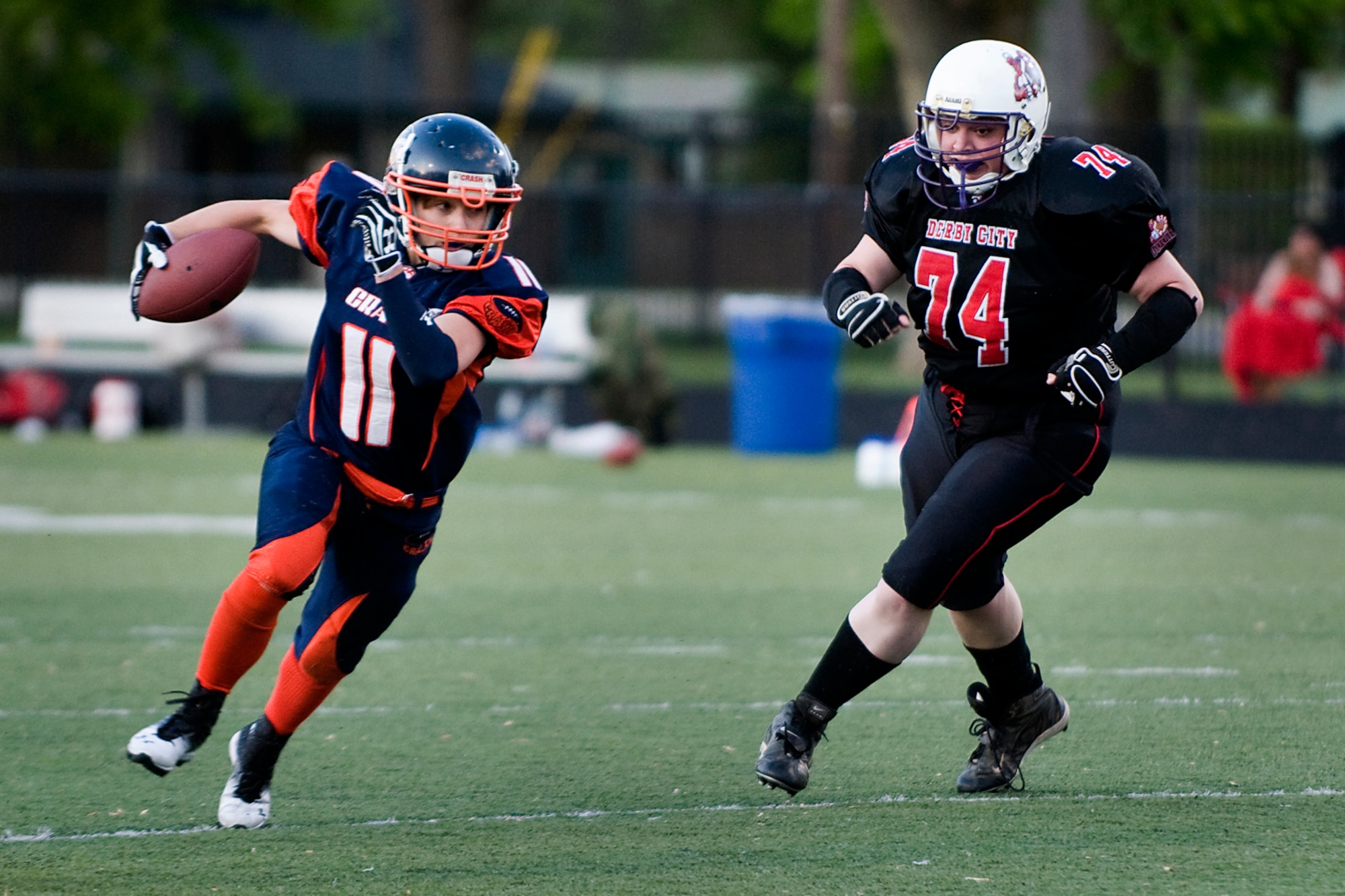 Jenessa Anderson, an Indy Crash strong safety and running back who is also a cadet in an Indiana National Guard commissioning program, races past a Derby City opponent during a football game in Indianapolis May 17, 2014. The Crash currently has three members active in the Air Force Reserve, Army Reserve and Indiana Army National Guard, and many of the team's players are military veterans. (U.S. Air Force photo/Tech. Sgt. Mark R. W. Orders-Woempner)
