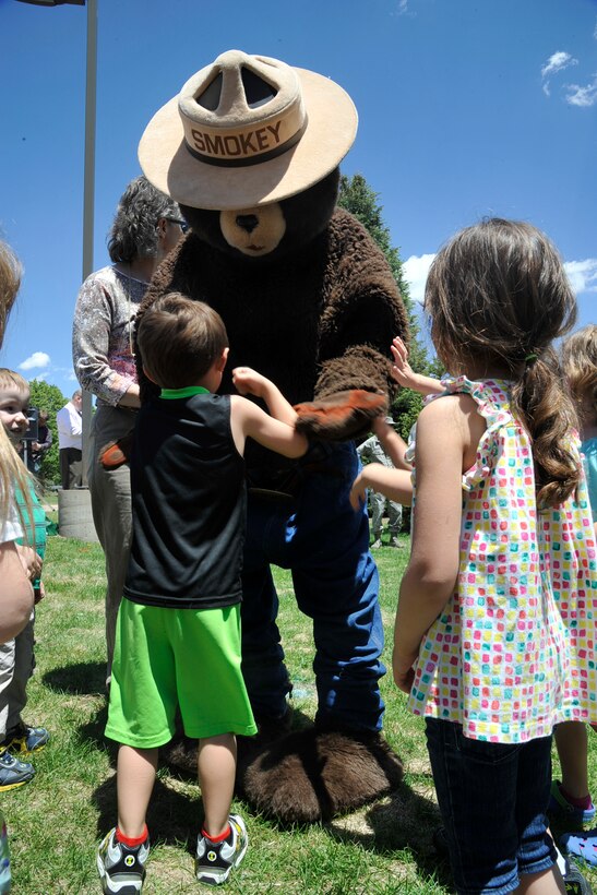 PETERSON AIR FORCE BASE, Colo. – Smokey Bear greets kids at the Peterson Child Development Center June 4 during the base’s Arbor Day celebration. Peterson AFB was presented the Tree City USA award, the 20th year in a row the base has received the honor. The award, given by the Arbor Day Foundation, recognizes excellence in urban forestry management. (U.S. Air Force photo/Robb Lingley)