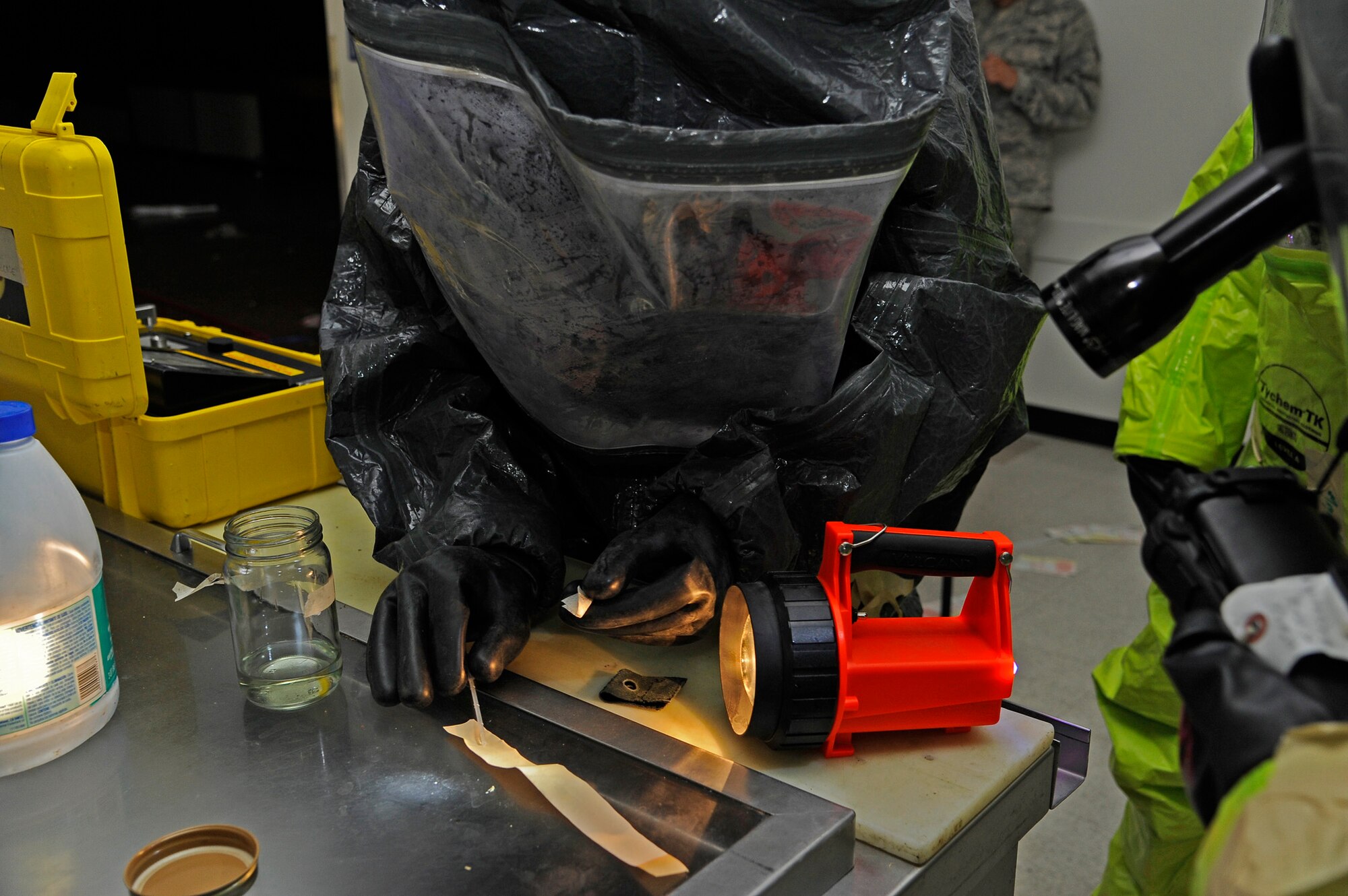 Tech. Sgt. Jonathan Maas, 341st Civil Engineer Squadron emergency management NCO in charge (center), identifies a simulated unknown chemical hazard using “Hazmat ID” detection equipment during a training session at the old Base Exchange on June 4. In order to detect unknown threats, emergency personnel use a wide array of specialized equipment such as gas meters to detect explosive atmospheres and alpha, beta particle detectors for radioactive environments. (U.S. Air Force photo/Airman 1st Class Collin Schmidt)