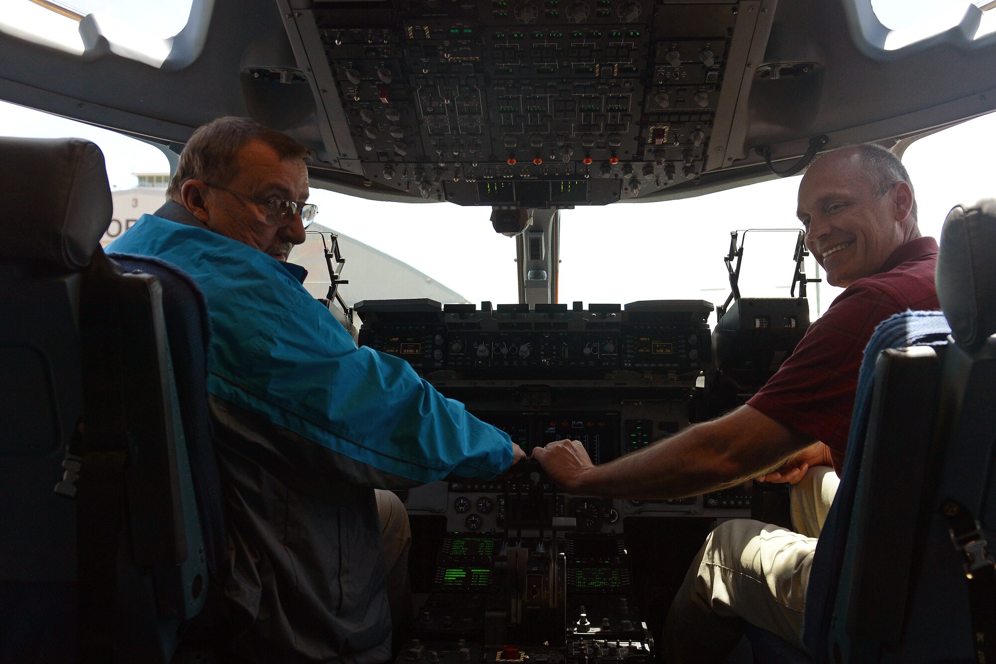 Mayor John Gawlik (left), Selah, Wash., and David Kelly, City Administrator for Selah, Wash., enjoy the view of a C-17 Globemaster III aircraft’s flight deck June 6, 2014 at Joint Base Lewis-McChord, Wash. Yakima city leaders visited McChord Field during their tour of JBLM to gain a better understanding of joint basing and Team McChord’s C-17 mission. (U.S. Force photo/Airman 1st Class Jacob Jimenez)