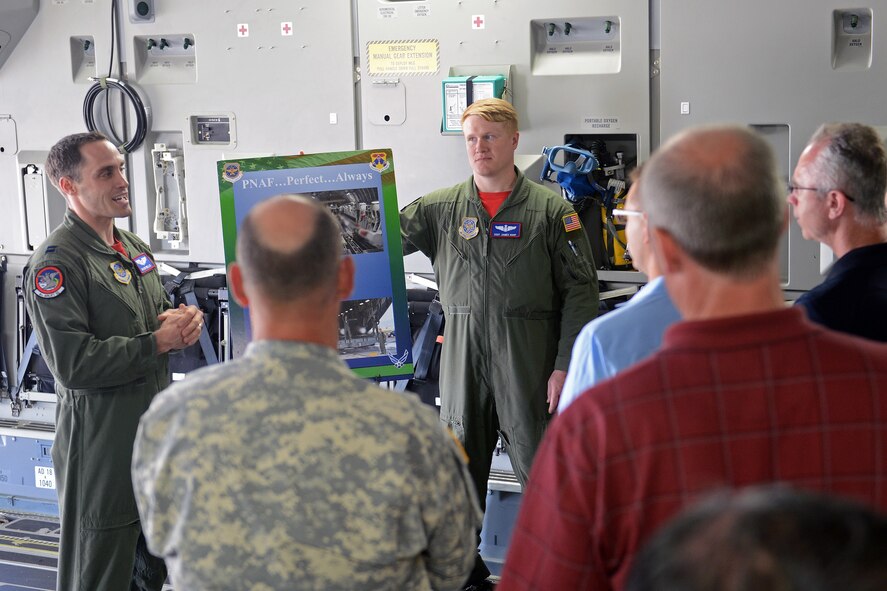 Capt. Brian Willis (left), 4th Airlift Squadron pilot, and Staff Sgt. James Harp, 4th AS loadmaster, speak to Yakima city leaders about Team McChord’s prime nuclear airlift force during a windshield tour June 6, 2014 at Joint Base Lewis-McChord, Wash. Yakima city leaders that toured JBLM, included Mayor Micah Cawley, City of Yakima, Wash., and Mayor John Gawlik, Selah, Wash. (U.S. Air Force photo/Airman 1st Class Jacob Jimenez) 