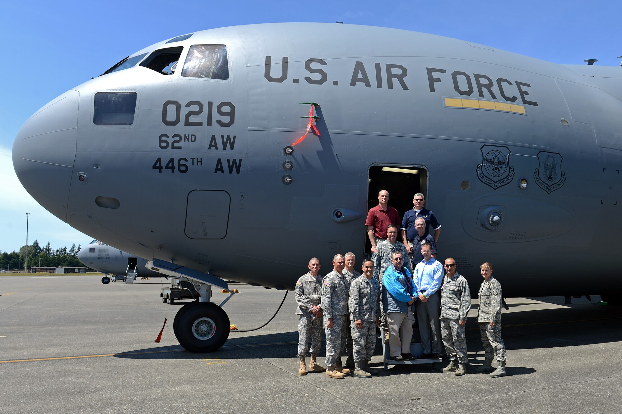 Yakima city leaders and base leadership pose for a photo in front of a C-17 Globemaster III aircraft during a base tour June 6, 2014 at Joint Base Lewis-McChord, Wash. Yakima city leaders toured JBLM to gain insight on service member transition programs and training.(U. S. Air Force photo/Airman 1st Class Jacob Jimenez)