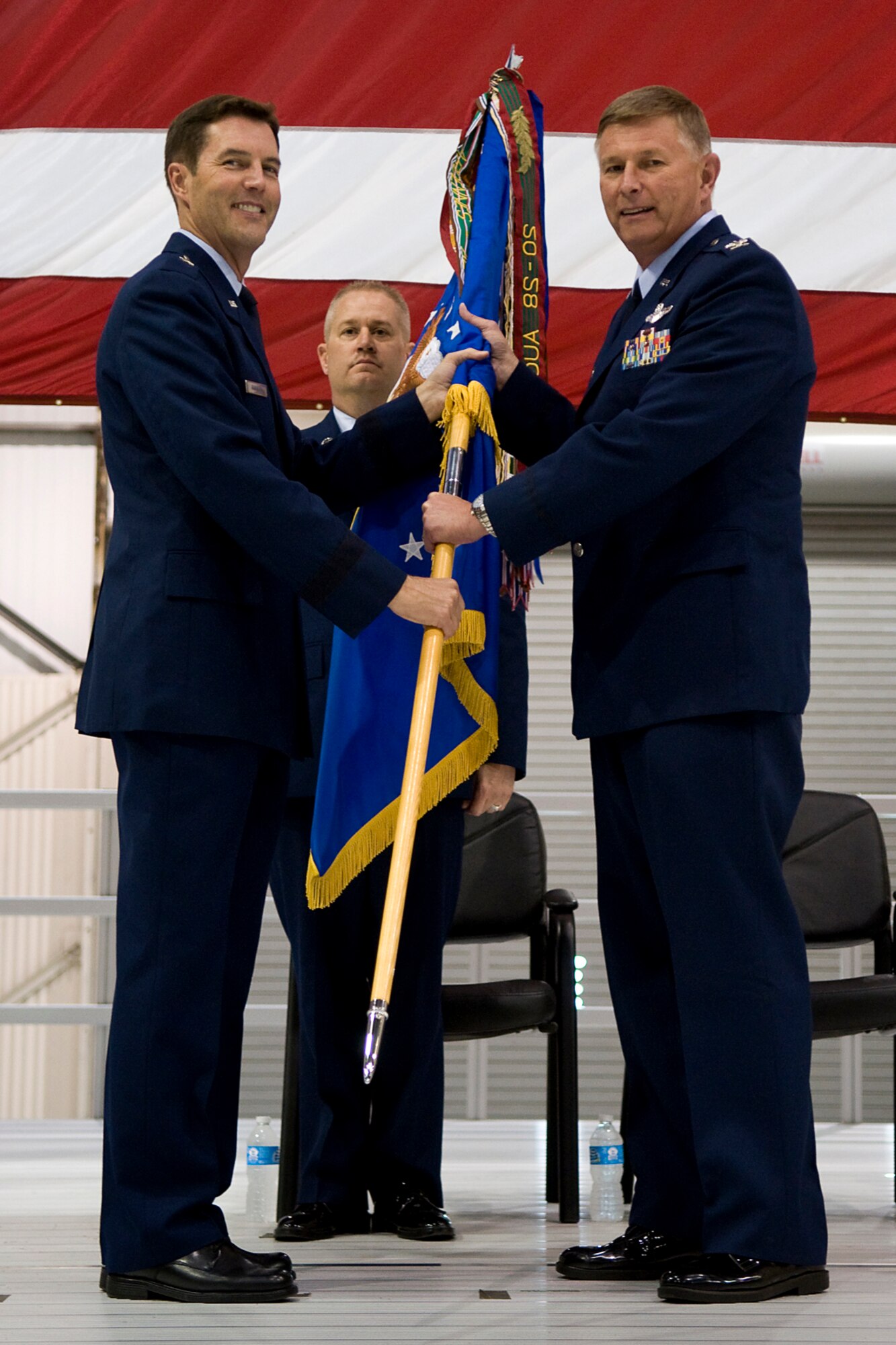 Brig. Gen. Jeffrey Barnson, 4th Air Force vice commander, presents the 434th Air Refueling Wing flag to Col. Douglas Schwartz as the colonel assumes command of the wing at Grissom Air Reserve, Base, Ind., June 8, 2014. Also pictured is Chief Master Sgt. Michael Bowden, 434th ARW interim command chief, who took part in the ceremony. Schwartz, who is a native Hoosier and graduate of Purdue University, West Lafayette, Ind., previously served at Grissom from 1992 to 2007. (U.S. Air Force photo/Tech. Sgt. Mark R. W. Orders-Woempner )
