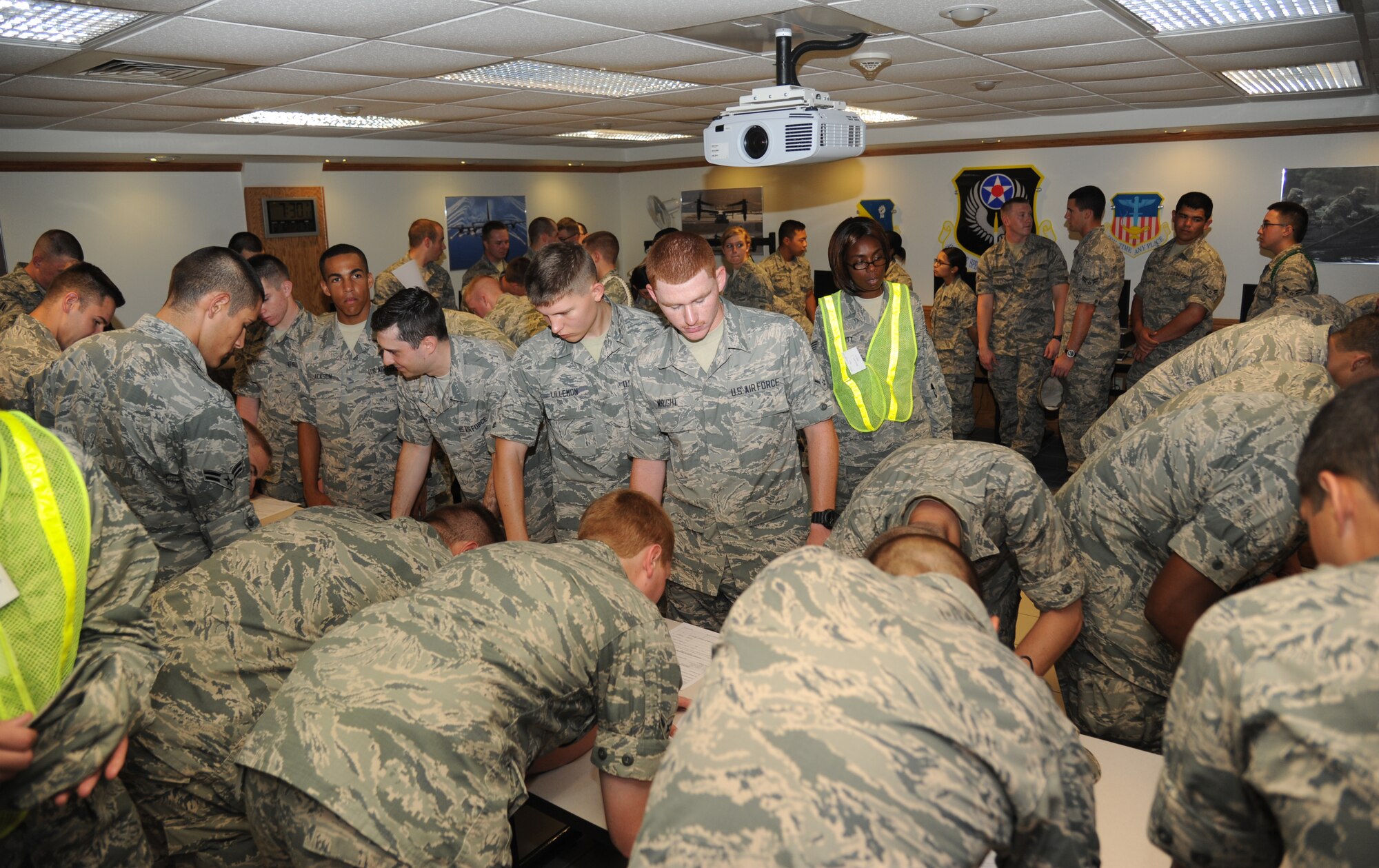 Airmen in the 335th Training Squadron complete hurricane shelter in-processing forms during a hurricane exercise June 6, 2014, at Allee Hall, Keesler Air Force Base, Miss.  The purpose of the exercise was to prepare Keesler for the current hurricane season.  (U.S. Air Force photo by Kemberly Groue)