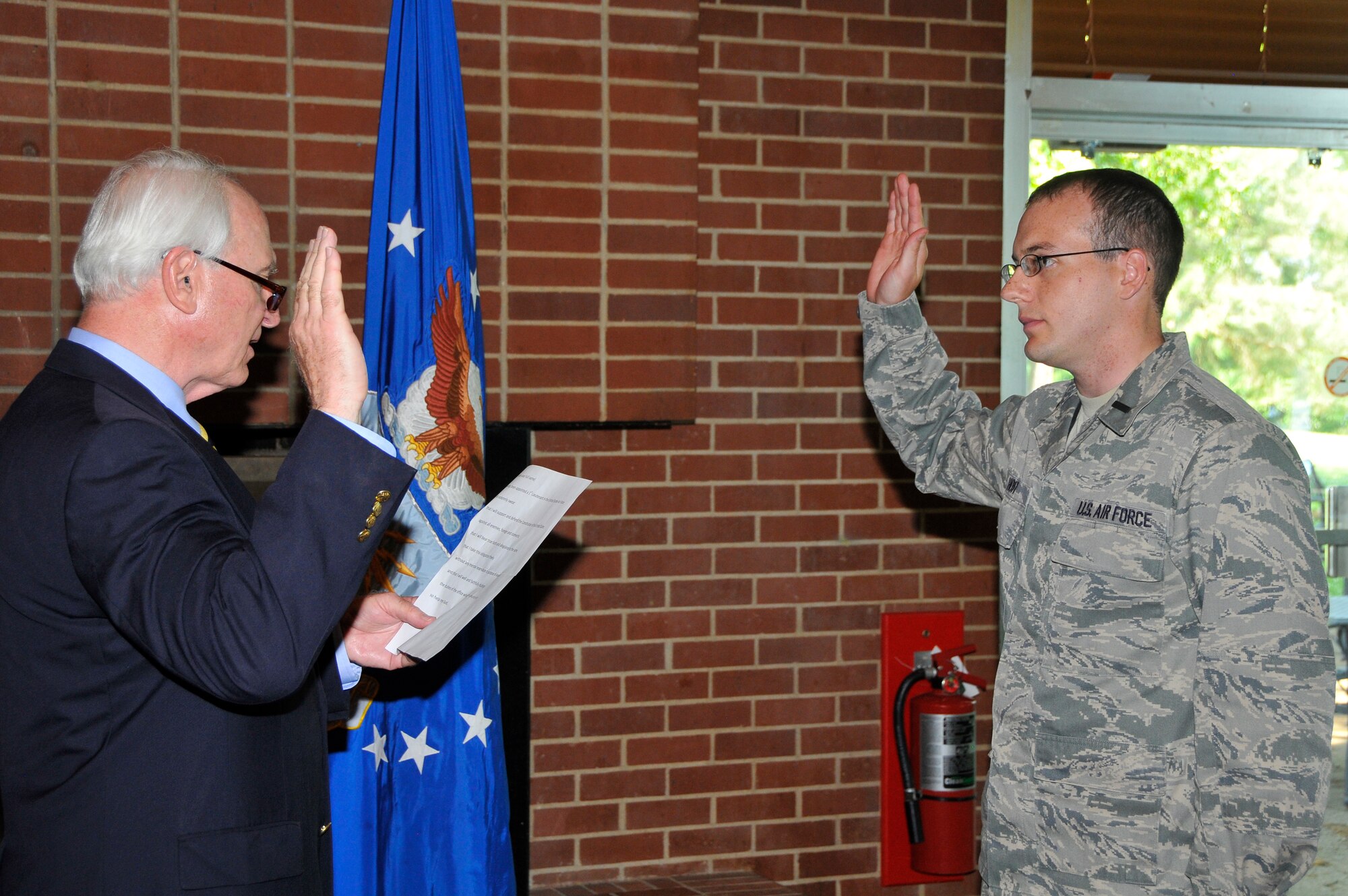 First Lt. Benjamin Hoff (right) takes his Oath of Office during a promotion ceremony where he was promoted to first lieutenant in the U.S. Air Force. The oath was presented by Hoff’s father, Gregory. (Photo by Jacqueline Cowan)