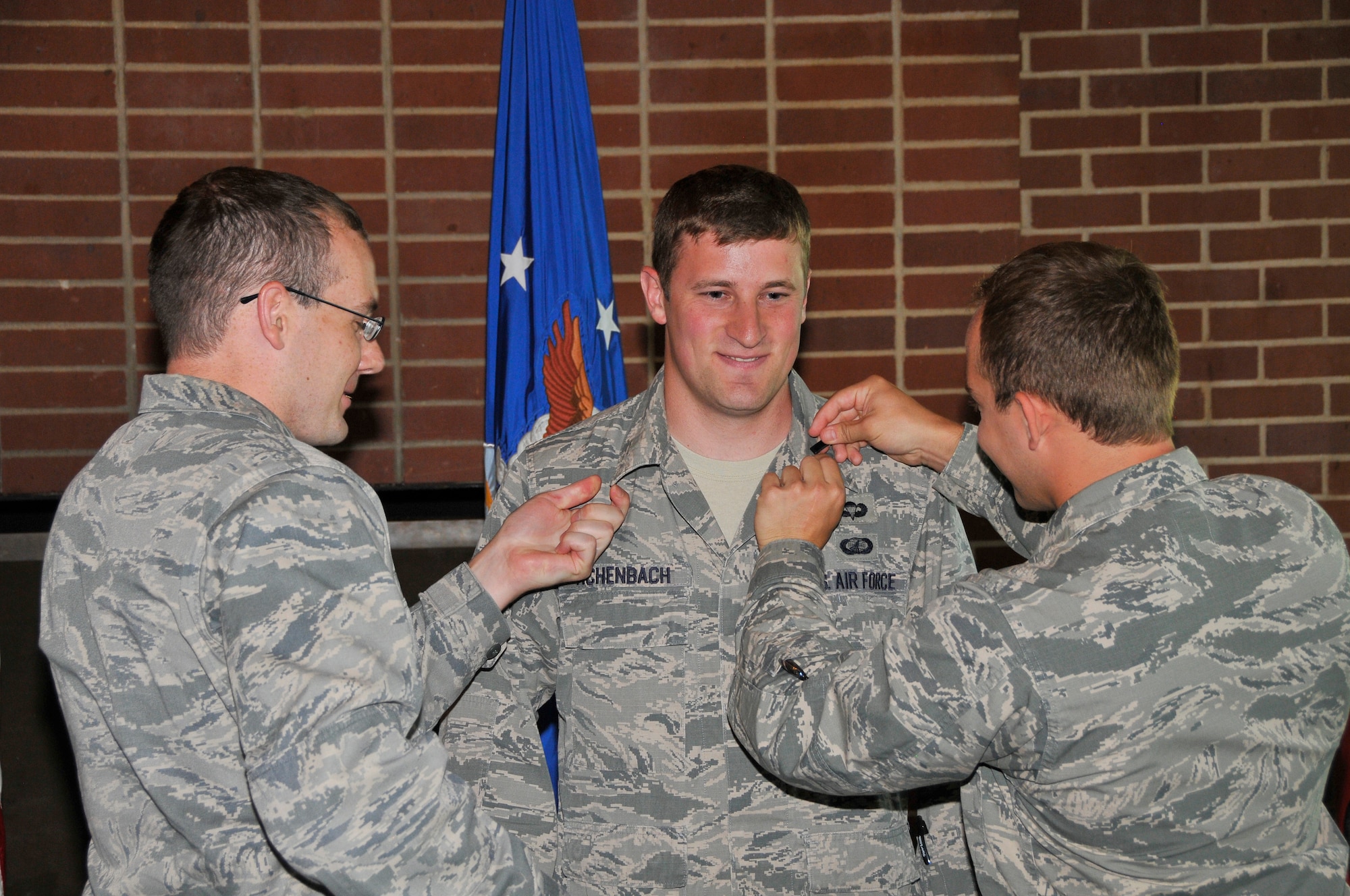 First Lt. Joseph Achenbach (center) is pinned by 1st Lt. Benjamin Hoff (left) and 1st Lt. Chance Johnson at a recent promotion ceremony where he was promoted to first lieutenant in the U.S. Air Force. (Photo by Jacqueline Cowan)