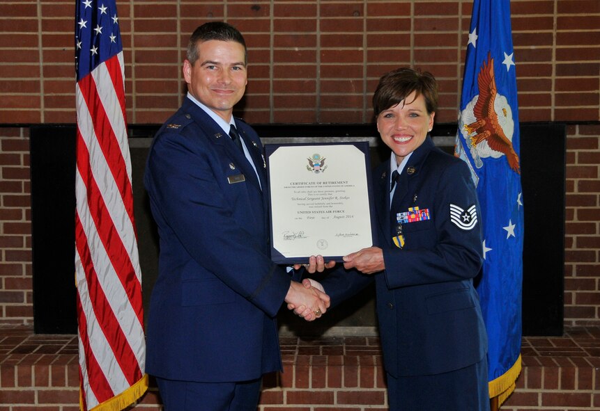 Tech. Sgt. Jennifer Stokes received her Certificate of Retirement from Arnold Engineering Development Complex (AEDC) Commander Col. Raymond Toth at a recent retirement ceremony. Stokes retired early with 16 years of service in the U.S. Air Force. She was the AEDC noncommissioned officer in charge of out-patient services and an independent duty medical technician. (Photo by Jacqueline Cowan)