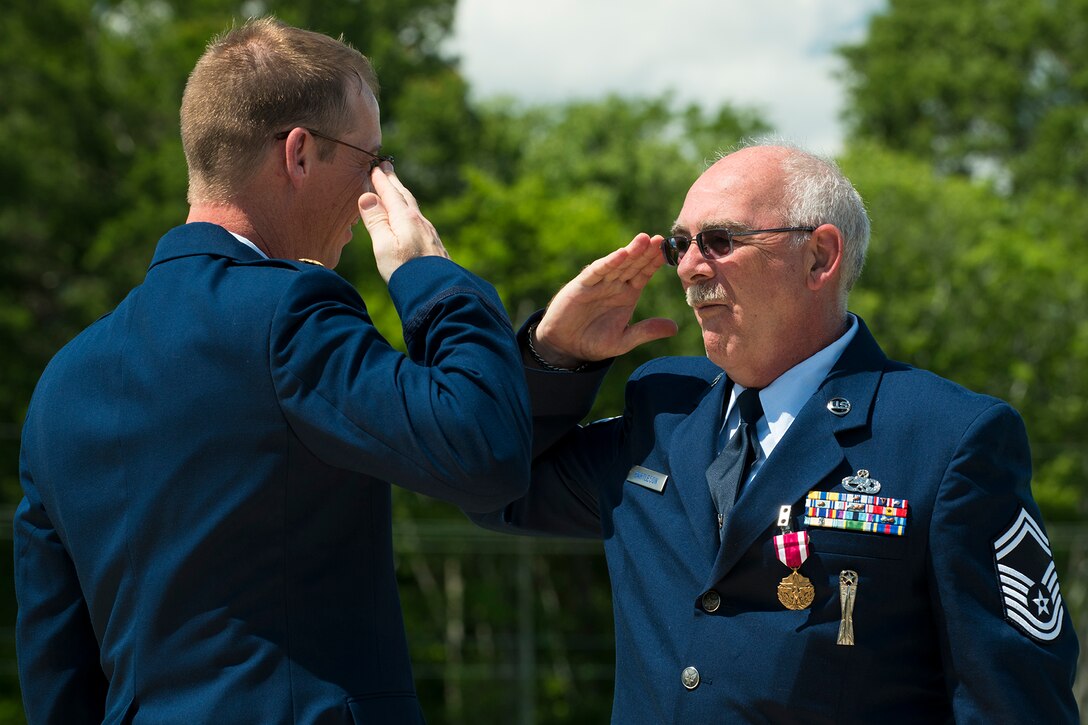 U.S. Air Force Senior Master Sgt. Jack Bartleson salutes Maj. Warren Crabtree, 707th Maintenance Squadron commander, after being presented the Air Force Meritorious Service Medal during his retirement ceremony on June 7, 2014, Barksdale Air Force Base, La. Bartleson, a munitions specialist assigned to the 307th Maintenance Squadron is retiring from the Air Force Reserve after 30 years of service. (U.S. Air Force photo by Master Sgt. Greg Steele/Released)