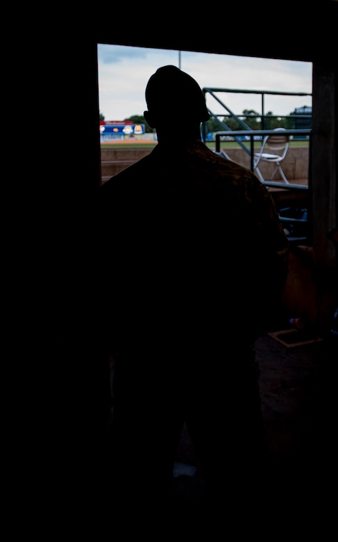 Airman 1st Class Kyren Gantt, 628th Security Forces Squadron patrolman, looks out from the dugout June 6, 2014, at Joseph P. Riley Park in Charleston, S.C. Gantt’s family was on the field listening to what they believed was a pre-recorded message from him, when in fact, it was actually Gantt speaking into a microphone from the dugout. After delivering his message, he walked onto the field where he reunited with his family who he had not seen in eight months. (U.S. Air Force photo/ Airman 1st Class Clayton Cupit)