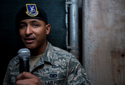 Airman 1st Class Kyren Gantt, 628th Security Forces Squadron patrolman, delivers a message to his family June 6, 2014, at Joseph P. Riley Park in Charleston, S.C. Gantt’s family was on the field listening to what they believed was a pre-recorded message from him, but it was actually him speaking into a microphone from the dugout. After delivering his message, he walked onto the field where he reunited with his family who he had not seen in eight months. (U.S. Air Force photo/ Airman 1st Class Clayton Cupit)