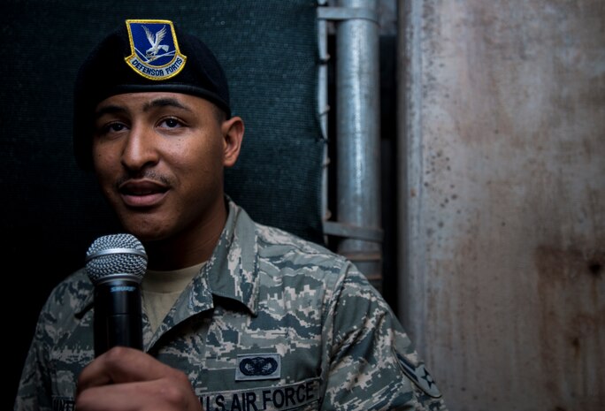 Airman 1st Class Kyren Gantt, 628th Security Forces Squadron patrolman, delivers a message to his family June 6, 2014, at Joseph P. Riley Park in Charleston, S.C. Gantt’s family was on the field listening to what they believed was a pre-recorded message from him, but it was actually him speaking into a microphone from the dugout. After delivering his message, he walked onto the field where he reunited with his family who he had not seen in eight months. (U.S. Air Force photo/ Airman 1st Class Clayton Cupit)