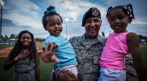 Airman 1st Class Kyren Gantt, 628th Security Forces Squadron patrolman, is reunited with his family June 6, 2014, at Joseph P. Riley Park in Charleston, S.C. Gantt just returned from an eight-month deployment to Osan Air Base, Republic of Korea. (U.S. Air Force photo/ Airman 1st Class Clayton Cupit)