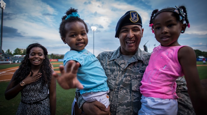 Airman 1st Class Kyren Gantt, 628th Security Forces Squadron patrolman, is reunited with his family June 6, 2014, at Joseph P. Riley Park in Charleston, S.C. Gantt just returned from an eight-month deployment to Osan Air Base, Republic of Korea. (U.S. Air Force photo/ Airman 1st Class Clayton Cupit)
