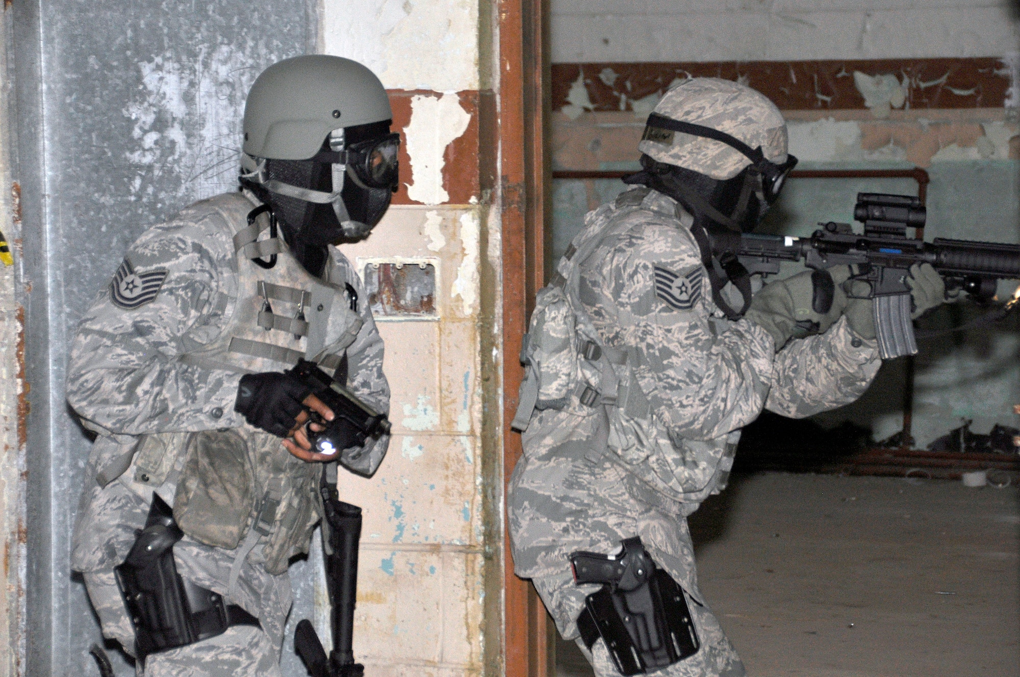 Two members of the 482nd Security Forces Squadron, Homestead Air Reserve Base, Fla., prepare to “clear” a room during an active shooter training exercise held during the base’s June Unit Training Assembly. (U.S. Air Force photo/Senior Airman Nicholas Caceres)