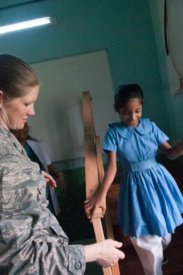 U.S. Air Force Lt. Col. Deanna Medina, an occupational therapist with the 48th Medical Group from RAF Lakenheath, UK , works with a child on therapy stairs at the Proyash School Rangpur Cantonment on June 2, 2014 during Operation Pacific Angel. Students range in age from 6-16 years old and all receive specialized education including speech language therapy, occupational therapy and elementary education. . (U.S. Air Force photo/ Capt. Cait Suttie)

