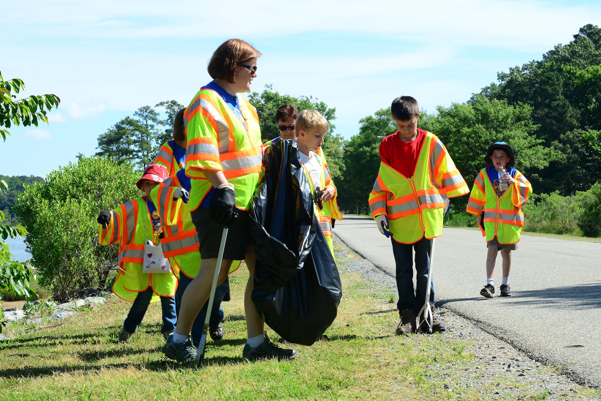 Volunteers gather trash during the 26th Annual Clean the Bay Day at Fort Eustis, Va., June 7, 2014. The volunteers covered about 12 miles of shoreline and collected almost 430 pounds of trash. (U.S. Air Force photo by Airman 1st Class Kimberly Nagle/Released)